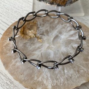 Silver is black link bracelet with white crystals look like diamonds